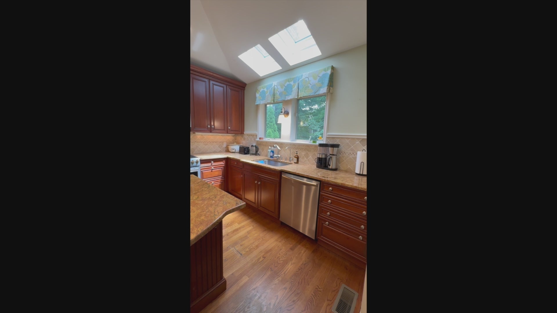 Load video: Custom wood kitchen cabinetry featuring crown molding and granite countertops