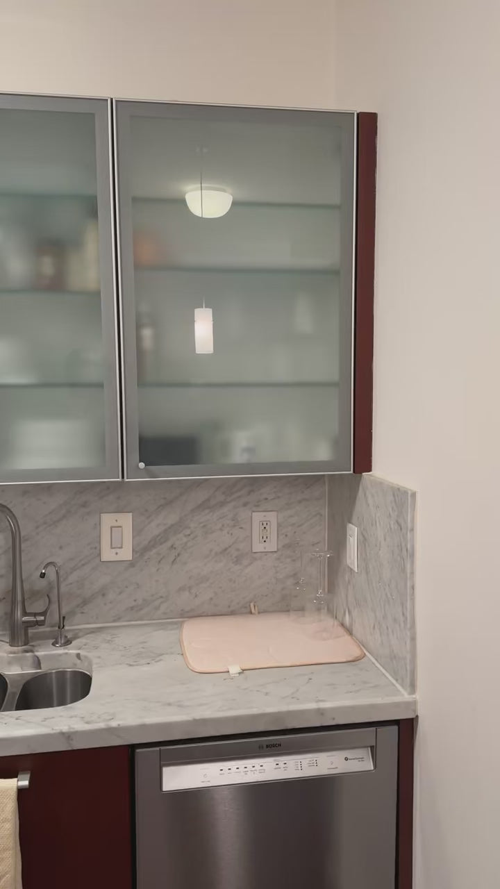 Load video: Poggenpohl Brown Toned Transitional Kitchen with Marble Countertops and Appliances