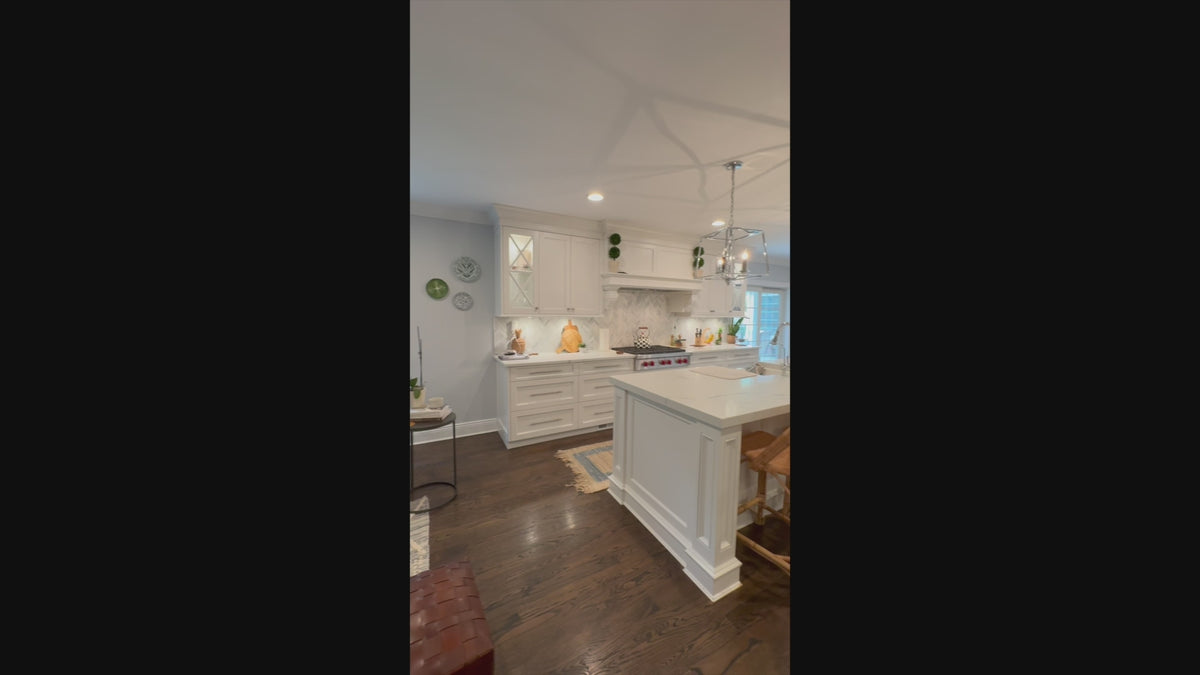 Load video: The Claridge transitional white kitchen cabinetry and central island with Wolf appliances