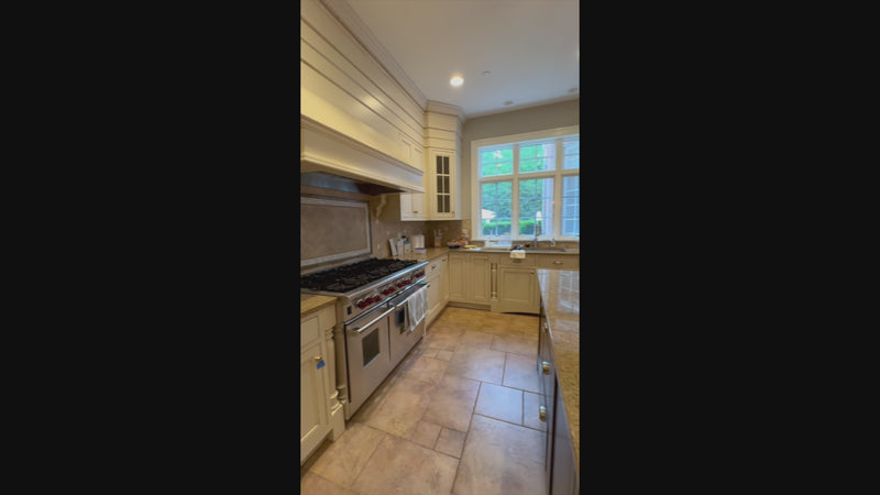 Omega transitional linen white kitchen with black island and custom cabinetry