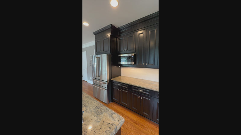 High-end architectural kitchen package in matte black with large island
