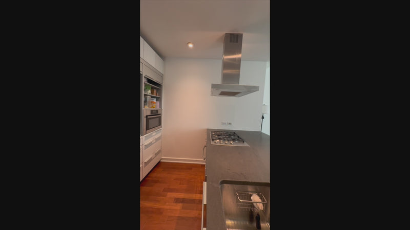Luxury architectural handleless kitchen cabinetry in minimalist gray and white finish
