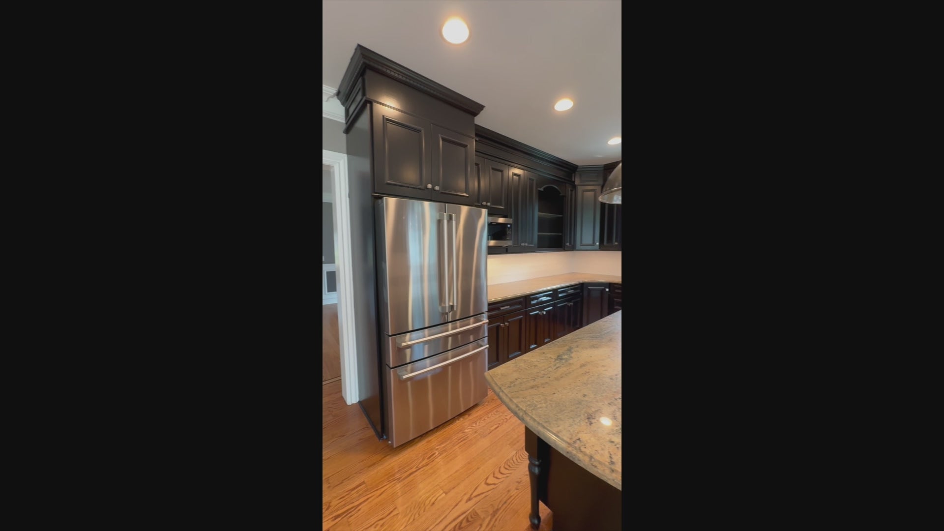 Load video: The Onyx transitional jet black kitchen suite with central island and appliances